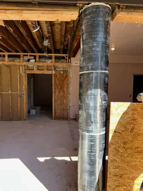 FRP fabric wrapped around a structural concrete beam in a framed building
