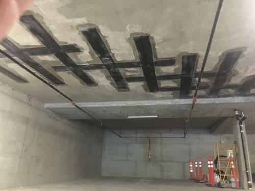 Externally bonded fiber reinforced polymer strips on the underside of a concrete deck